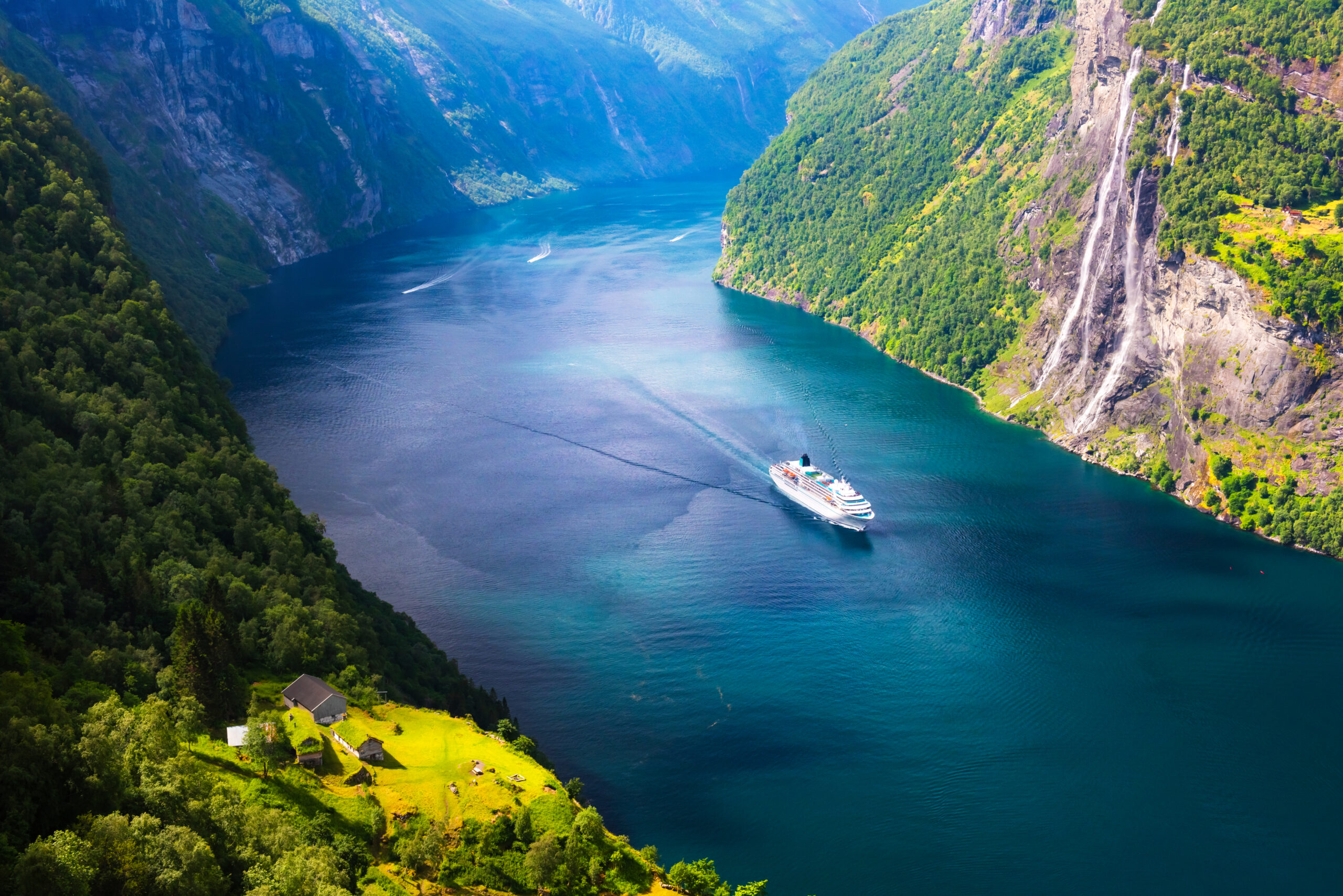 A big cruise liner in clear azure water of Sunnylvsfjorden fjord