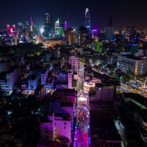 Illuminated_Bui_Vien_Party_Street_And_Ho_Chi_Minh_City_Skyline_At_Night._Aerial._original_3050437_MA